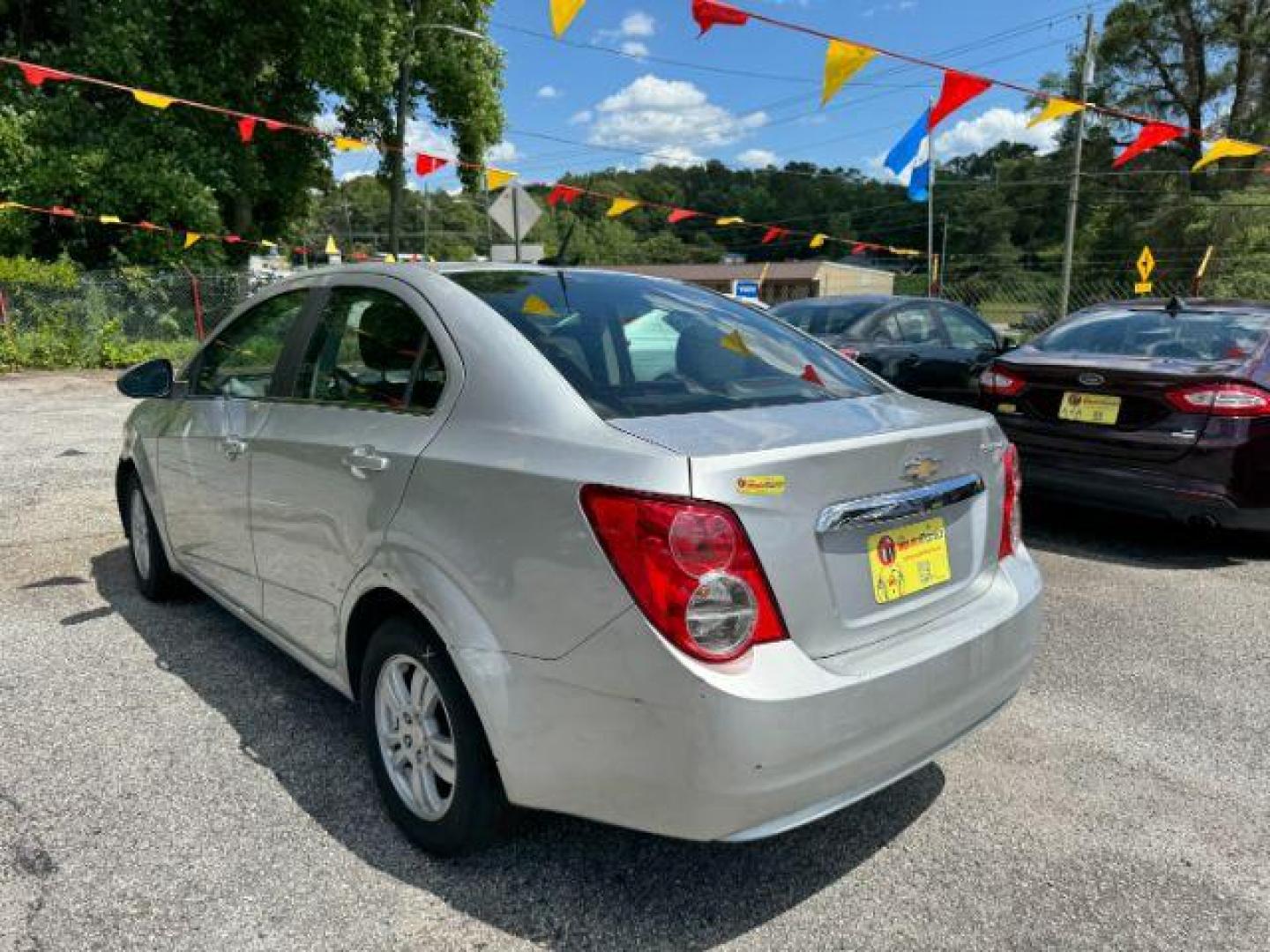 2014 Silver Chevrolet Sonic LT Auto Sedan (1G1JC5SH9E4) with an 1.8L L4 DOHC 24V engine, 6-Speed Automatic transmission, located at 1806 Veterans Memorial Hwy SW, Austell, GA, 30168, (770) 944-9558, 33.817959, -84.606987 - Photo#5