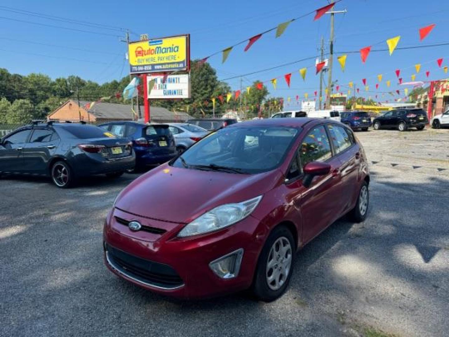 2011 RED Ford Fiesta SE Hatchback (3FADP4EJ6BM) with an 1.6L L4 DOHC 16V engine, 6-Speed Automatic transmission, located at 1806 Veterans Memorial Hwy SW, Austell, GA, 30168, (770) 944-9558, 33.817959, -84.606987 - Photo#0