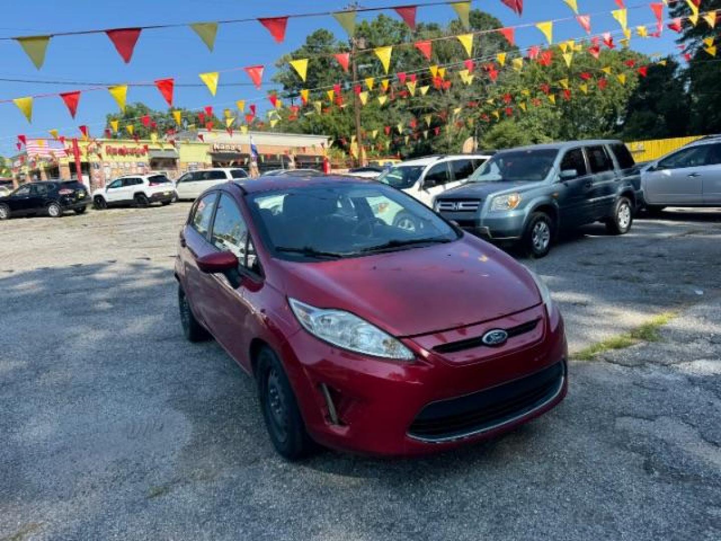 2011 RED Ford Fiesta SE Hatchback (3FADP4EJ6BM) with an 1.6L L4 DOHC 16V engine, 6-Speed Automatic transmission, located at 1806 Veterans Memorial Hwy SW, Austell, GA, 30168, (770) 944-9558, 33.817959, -84.606987 - Photo#2