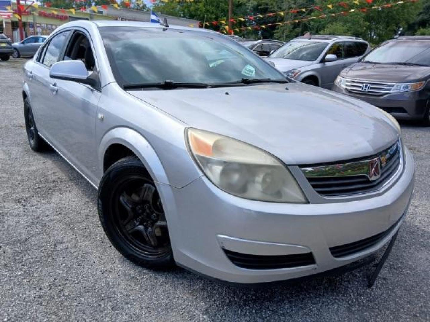 2009 Silver Saturn Aura XE (1G8ZS57B29F) with an 2.4L L4 DOHC 16V engine, 4-Speed Automatic transmission, located at 1806 Veterans Memorial Hwy SW, Austell, GA, 30168, (770) 944-9558, 33.817959, -84.606987 - Photo#0