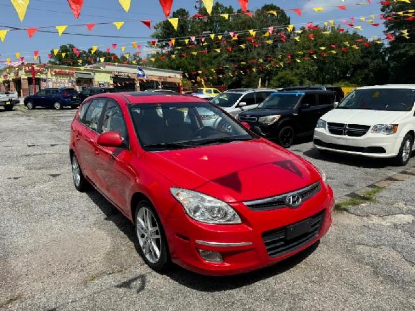 2009 Red Hyundai Elantra Automatic (KMHDC86E09U) with an 2.0L L4 DOHC 16V engine, 4-Speed Automatic transmission, located at 1806 Veterans Memorial Hwy SW, Austell, GA, 30168, (770) 944-9558, 33.817959, -84.606987 - Photo#2