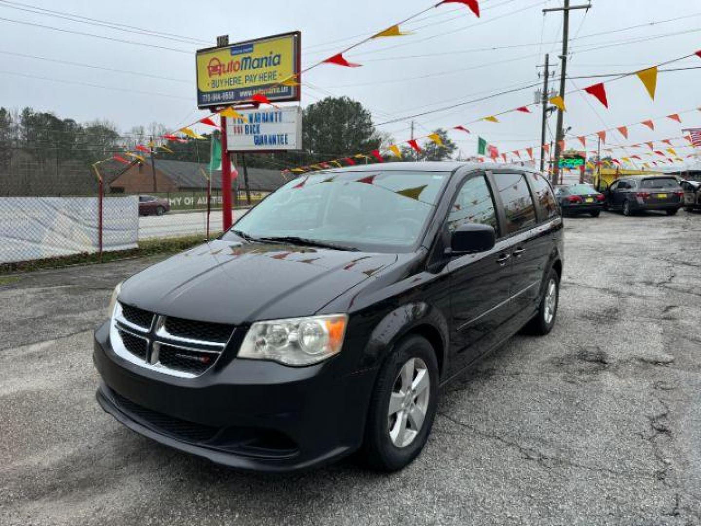 2013 Black Dodge Grand Caravan SE (2C4RDGBG3DR) with an 3.6L V6 DOHC 24V engine, 6-Speed Automatic transmission, located at 1806 Veterans Memorial Hwy SW, Austell, GA, 30168, (770) 944-9558, 33.817959, -84.606987 - Photo#0