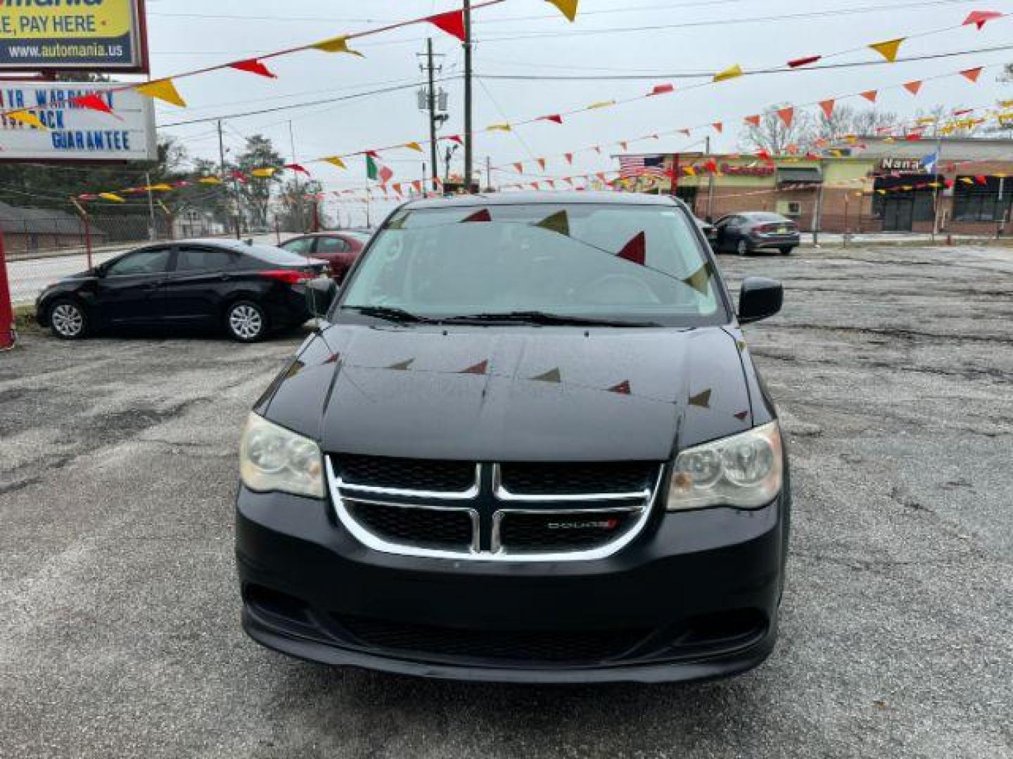 2013 Black Dodge Grand Caravan SE (2C4RDGBG3DR) with an 3.6L V6 DOHC 24V engine, 6-Speed Automatic transmission, located at 1806 Veterans Memorial Hwy SW, Austell, GA, 30168, (770) 944-9558, 33.817959, -84.606987 - Photo#1