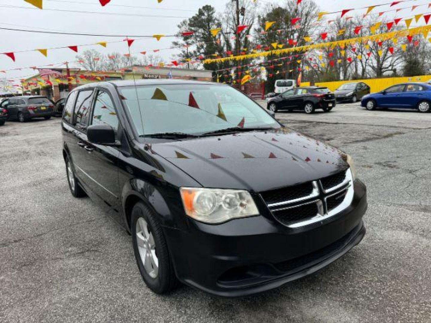 2013 Black Dodge Grand Caravan SE (2C4RDGBG3DR) with an 3.6L V6 DOHC 24V engine, 6-Speed Automatic transmission, located at 1806 Veterans Memorial Hwy SW, Austell, GA, 30168, (770) 944-9558, 33.817959, -84.606987 - Photo#2