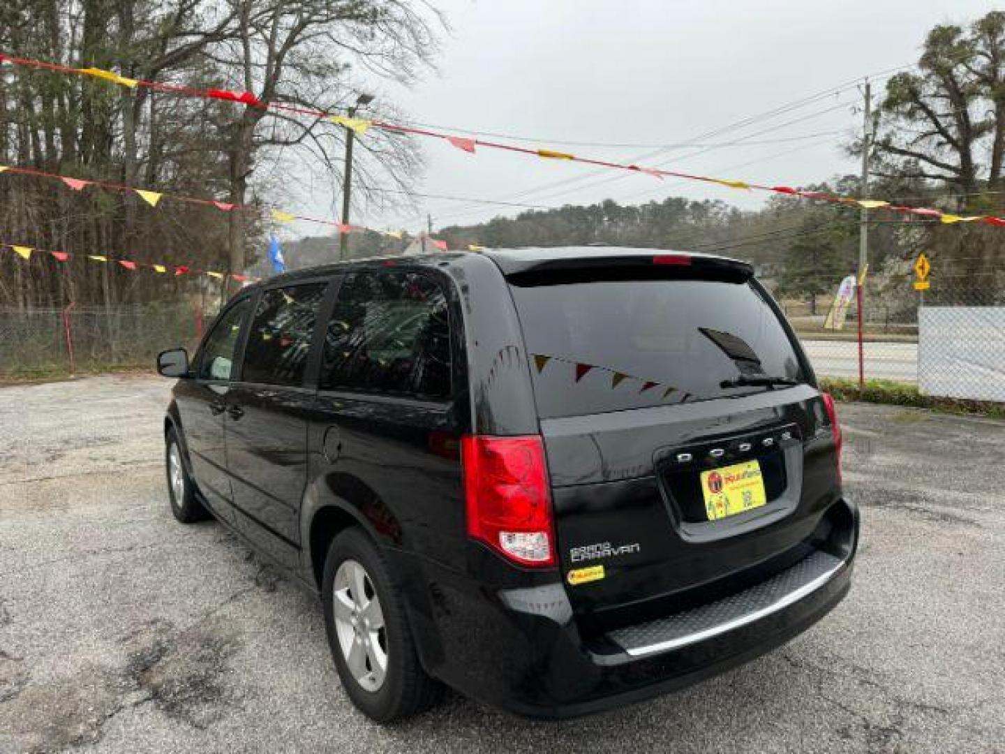 2013 Black Dodge Grand Caravan SE (2C4RDGBG3DR) with an 3.6L V6 DOHC 24V engine, 6-Speed Automatic transmission, located at 1806 Veterans Memorial Hwy SW, Austell, GA, 30168, (770) 944-9558, 33.817959, -84.606987 - Photo#6