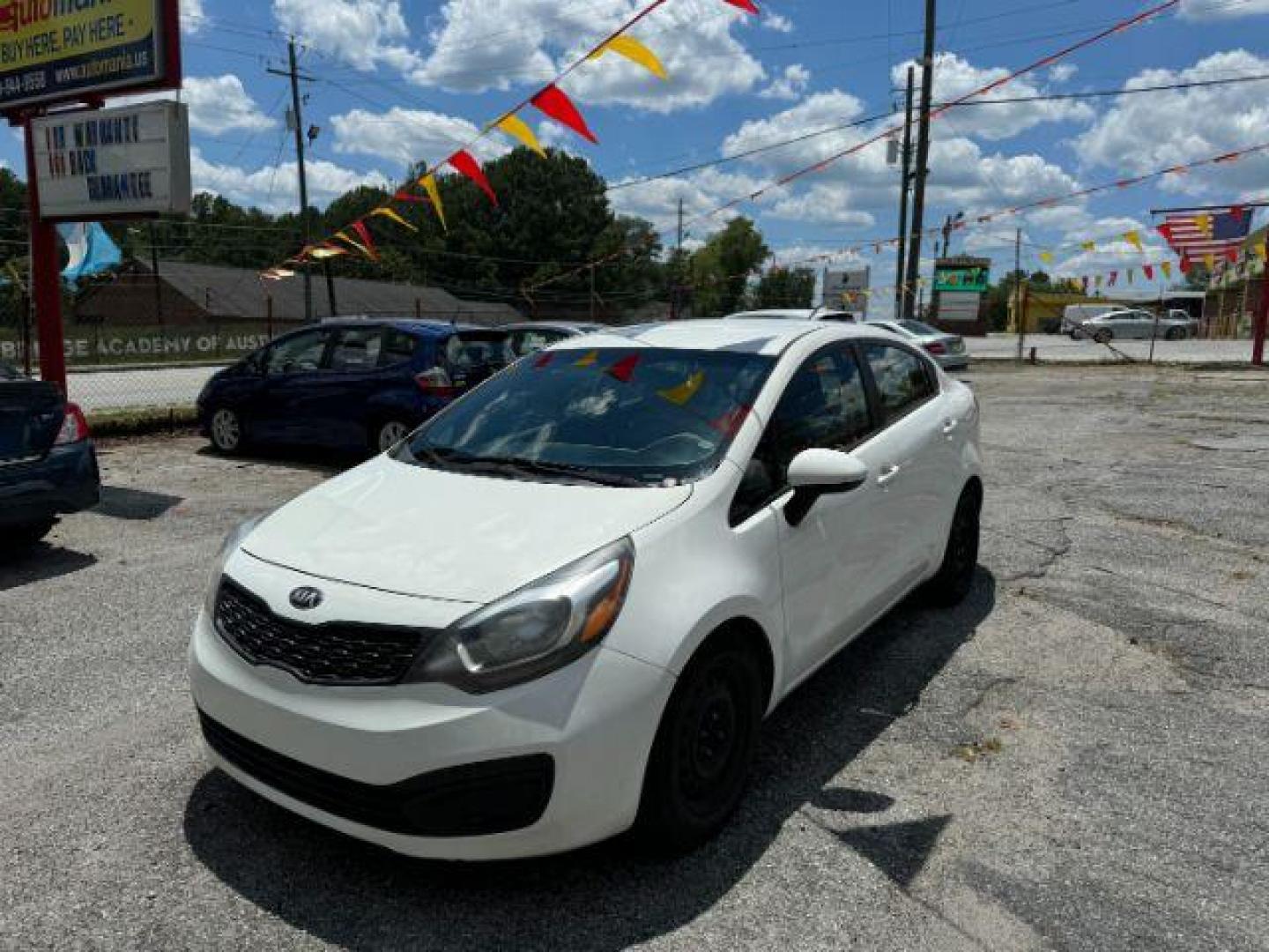 2015 White Kia Rio LX (KNADM4A37F6) with an 1.6L L4 DOHC 16V engine, 4-Speed Automatic transmission, located at 1806 Veterans Memorial Hwy SW, Austell, GA, 30168, (770) 944-9558, 33.817959, -84.606987 - Photo#0