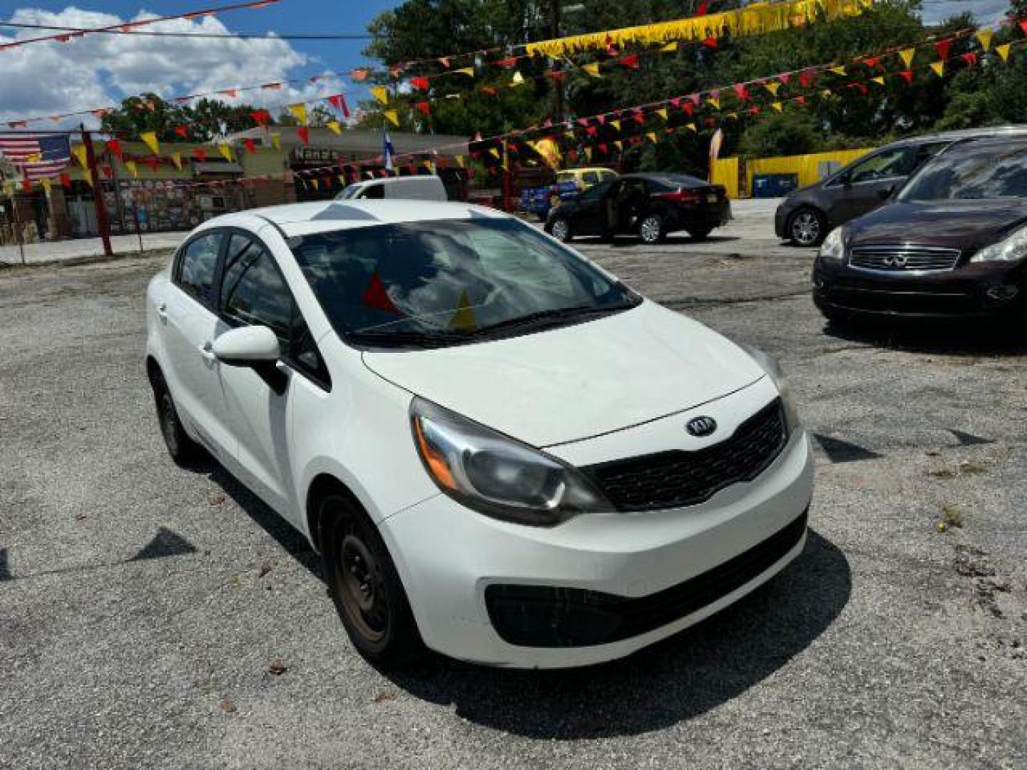 2015 White Kia Rio LX (KNADM4A37F6) with an 1.6L L4 DOHC 16V engine, 4-Speed Automatic transmission, located at 1806 Veterans Memorial Hwy SW, Austell, GA, 30168, (770) 944-9558, 33.817959, -84.606987 - Photo#2