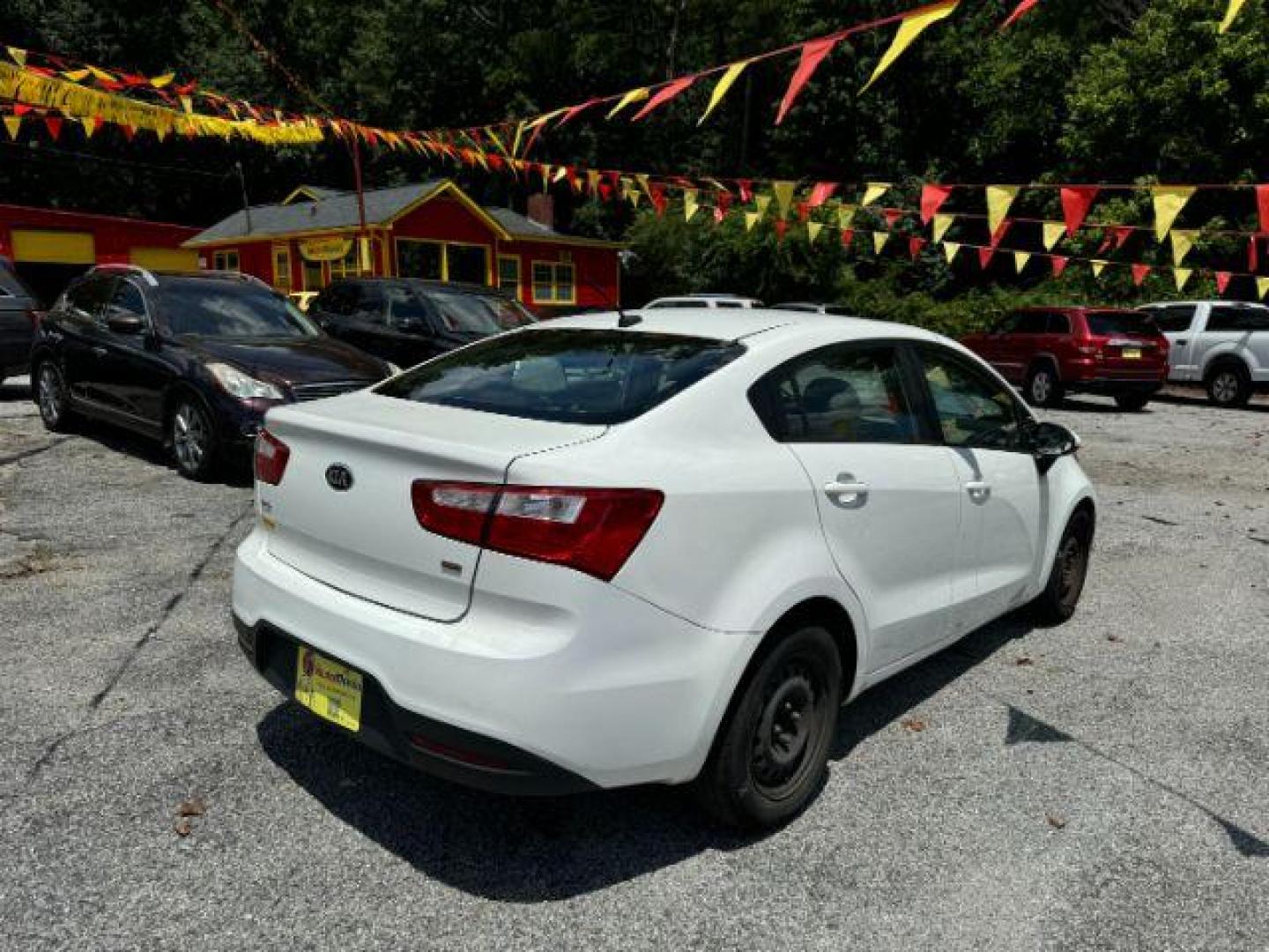 2015 White Kia Rio LX (KNADM4A37F6) with an 1.6L L4 DOHC 16V engine, 4-Speed Automatic transmission, located at 1806 Veterans Memorial Hwy SW, Austell, GA, 30168, (770) 944-9558, 33.817959, -84.606987 - Photo#3