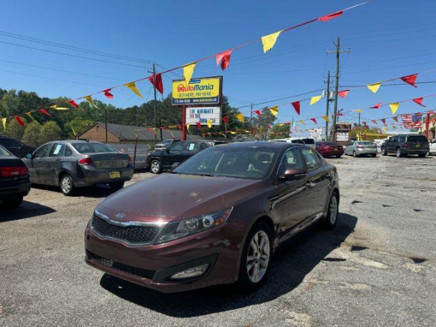 2012 Maroon Kia Optima LX AT (5XXGM4A74CG) with an 2.4L L4 DOHC 16V engine, 6-Speed Automatic transmission, located at 1806 Veterans Memorial Hwy SW, Austell, GA, 30168, (770) 944-9558, 33.817959, -84.606987 - Photo#0