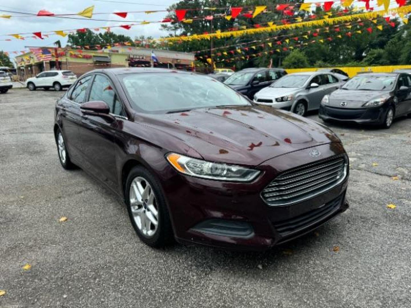 2013 Burgundy Ford Fusion SE (3FA6P0HRXDR) with an 1.6L L4 DOHC 16V engine, 5-Speed Automatic transmission, located at 1806 Veterans Memorial Hwy SW, Austell, GA, 30168, (770) 944-9558, 33.817959, -84.606987 - Photo#2