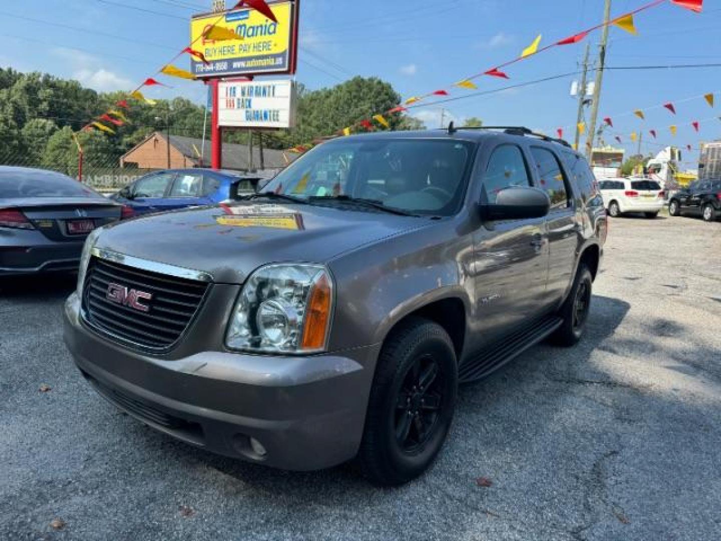 2011 Brown GMC Yukon SLT1 2WD (1GKS1CE09BR) with an 5.3L V8 OHV 16V FFV engine, 6-Speed Automatic transmission, located at 1806 Veterans Memorial Hwy SW, Austell, GA, 30168, (770) 944-9558, 33.817959, -84.606987 - Photo#0