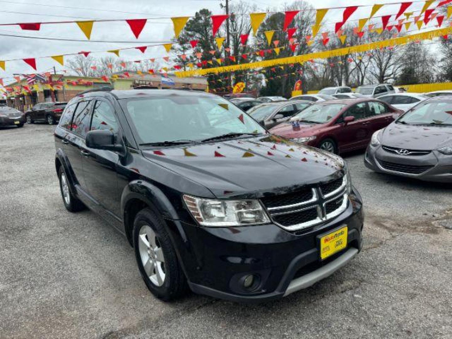 2012 Black Dodge Journey SXT (3C4PDCBG1CT) with an 3.6L V6 DOHC 24V engine, 6-Speed Automatic transmission, located at 1806 Veterans Memorial Hwy SW, Austell, GA, 30168, (770) 944-9558, 33.817959, -84.606987 - Photo#2