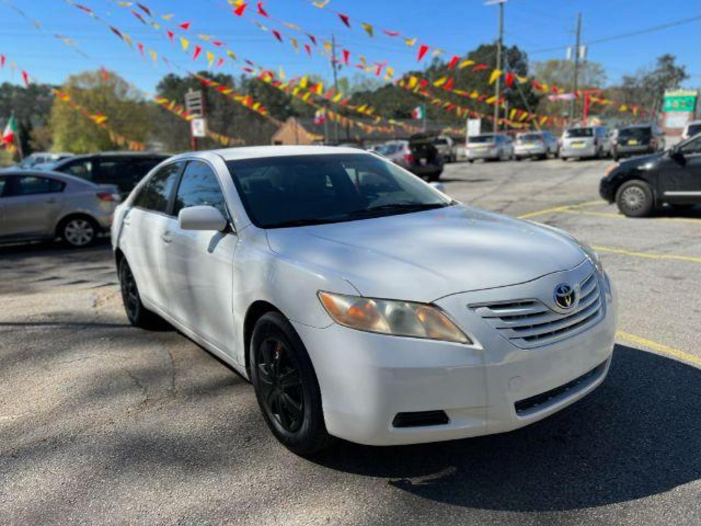 2007 White Toyota Camry LE 5-Spd AT (JTNBE46K773) with an 2.4L L4 DOHC 16V engine, 5-Speed Automatic transmission, located at 1806 Veterans Memorial Hwy SW, Austell, GA, 30168, (770) 944-9558, 33.817959, -84.606987 - Photo#2