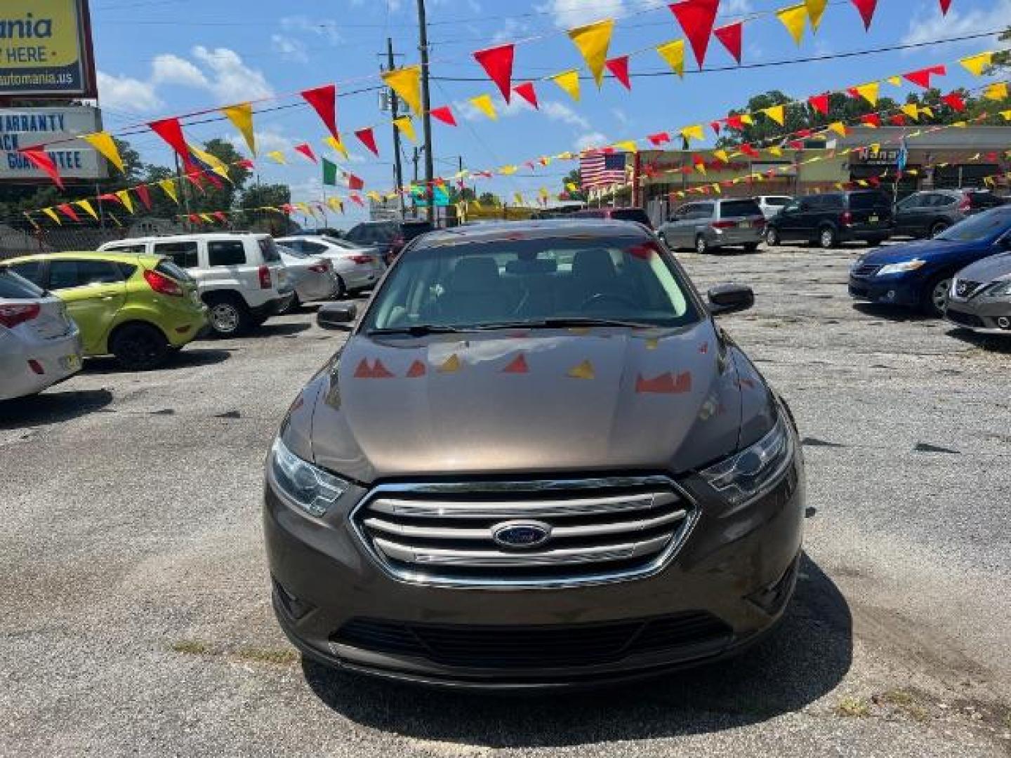 2015 Brown Ford Taurus SEL FWD (1FAHP2E88FG) with an 3.5L V6 DOHC 24V engine, 6-Speed Automatic transmission, located at 1806 Veterans Memorial Hwy SW, Austell, GA, 30168, (770) 944-9558, 33.817959, -84.606987 - Photo#1
