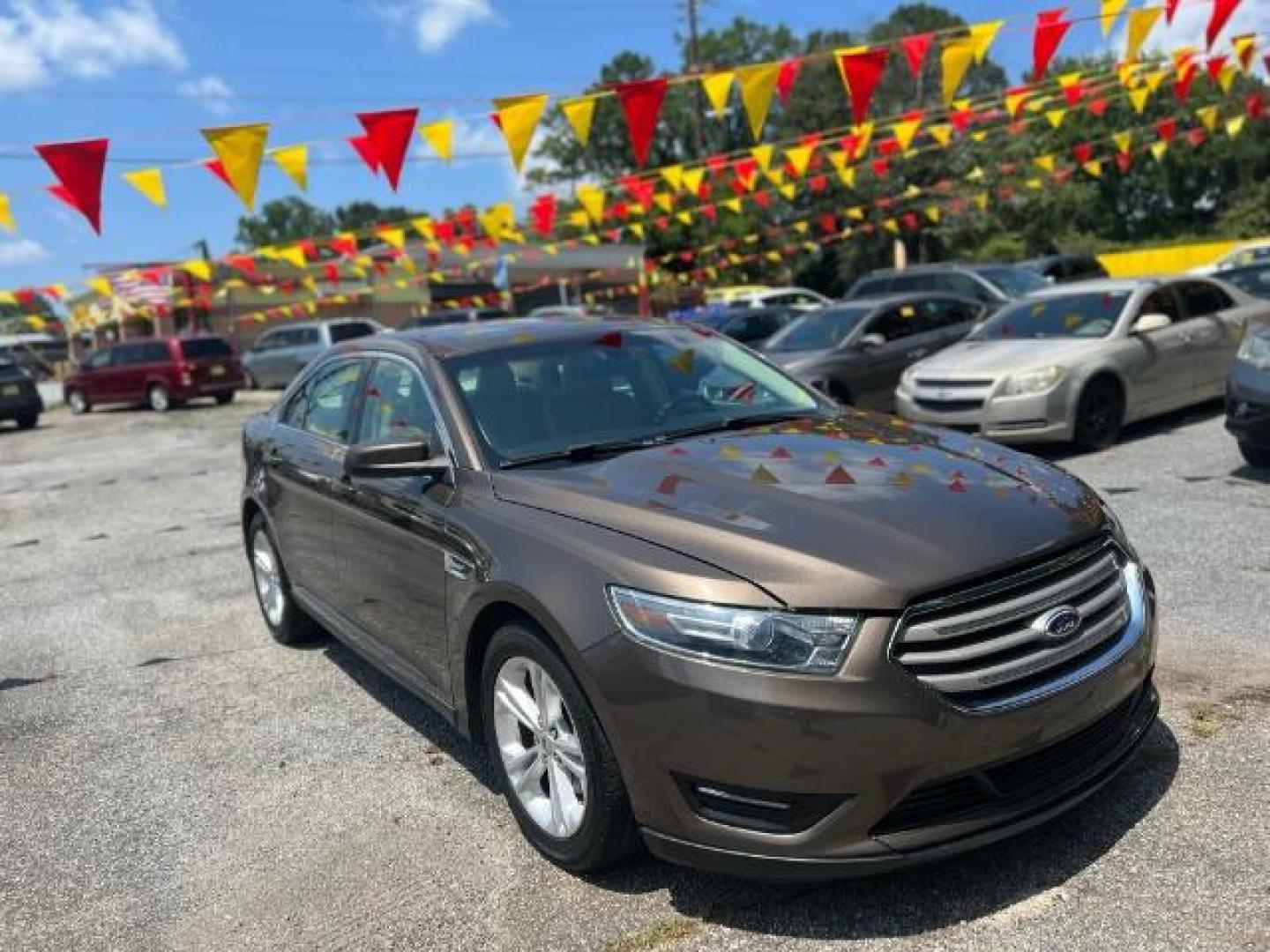 2015 Brown Ford Taurus SEL FWD (1FAHP2E88FG) with an 3.5L V6 DOHC 24V engine, 6-Speed Automatic transmission, located at 1806 Veterans Memorial Hwy SW, Austell, GA, 30168, (770) 944-9558, 33.817959, -84.606987 - Photo#2