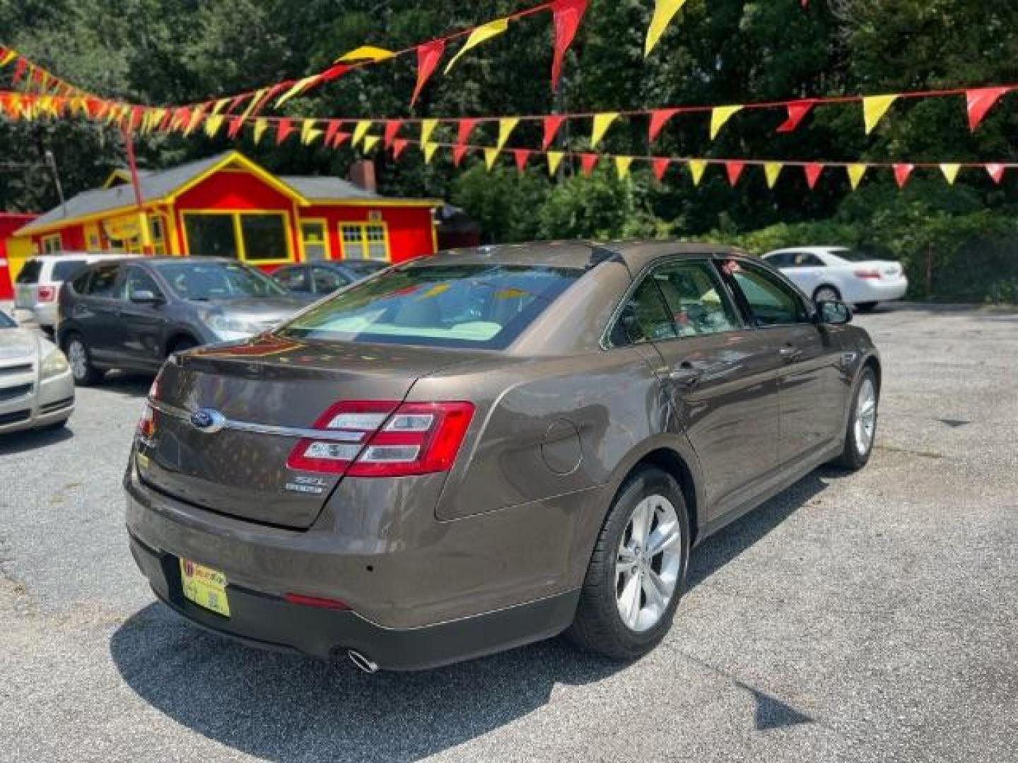 2015 Brown Ford Taurus SEL FWD (1FAHP2E88FG) with an 3.5L V6 DOHC 24V engine, 6-Speed Automatic transmission, located at 1806 Veterans Memorial Hwy SW, Austell, GA, 30168, (770) 944-9558, 33.817959, -84.606987 - Photo#3
