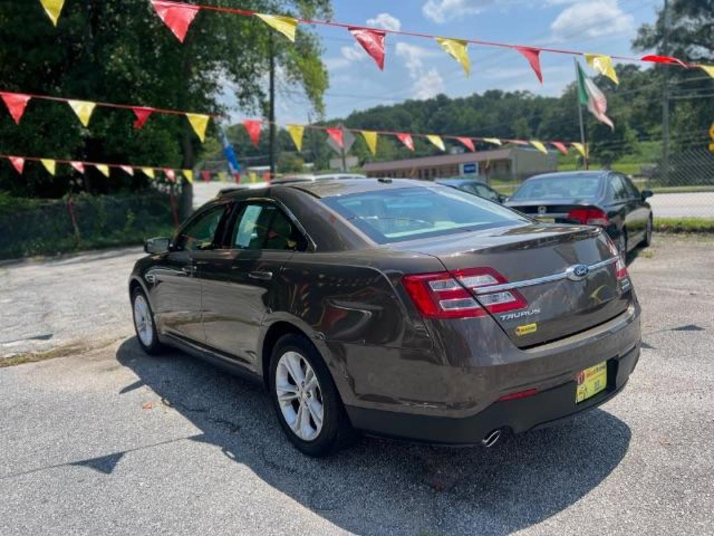 2015 Brown Ford Taurus SEL FWD (1FAHP2E88FG) with an 3.5L V6 DOHC 24V engine, 6-Speed Automatic transmission, located at 1806 Veterans Memorial Hwy SW, Austell, GA, 30168, (770) 944-9558, 33.817959, -84.606987 - Photo#5