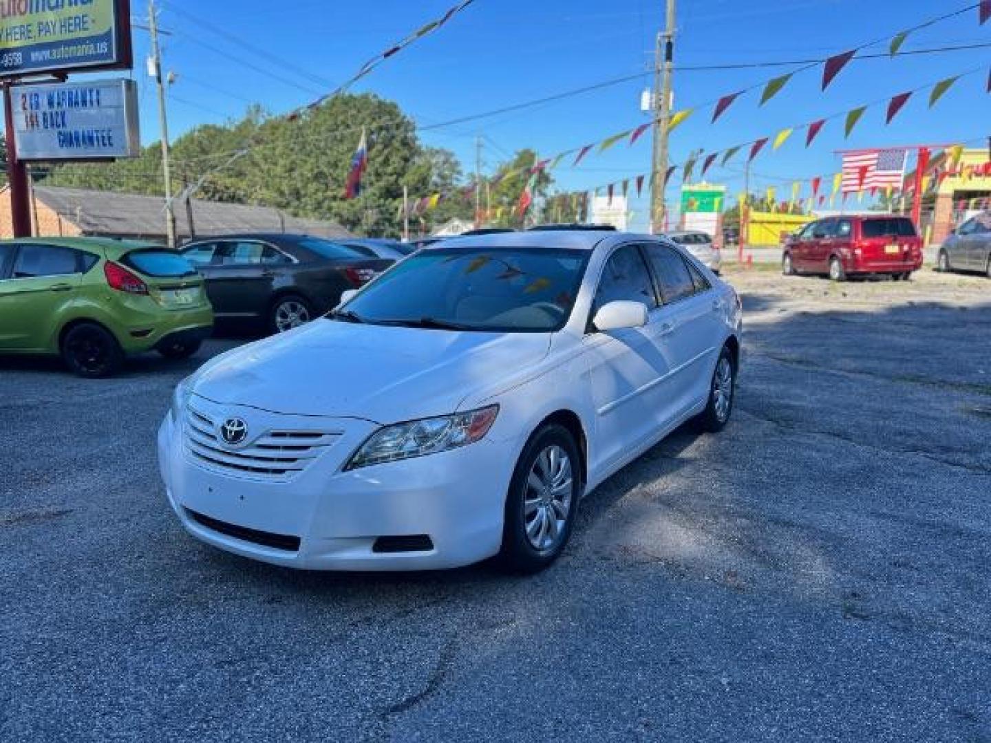 2009 White Toyota Camry LE 5-Spd AT (4T1BE46KX9U) with an 2.4L L4 DOHC 16V engine, 5-Speed Automatic transmission, located at 1806 Veterans Memorial Hwy SW, Austell, GA, 30168, (770) 944-9558, 33.817959, -84.606987 - Photo#0