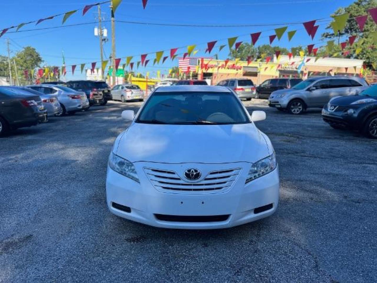 2009 White Toyota Camry LE 5-Spd AT (4T1BE46KX9U) with an 2.4L L4 DOHC 16V engine, 5-Speed Automatic transmission, located at 1806 Veterans Memorial Hwy SW, Austell, GA, 30168, (770) 944-9558, 33.817959, -84.606987 - Photo#1