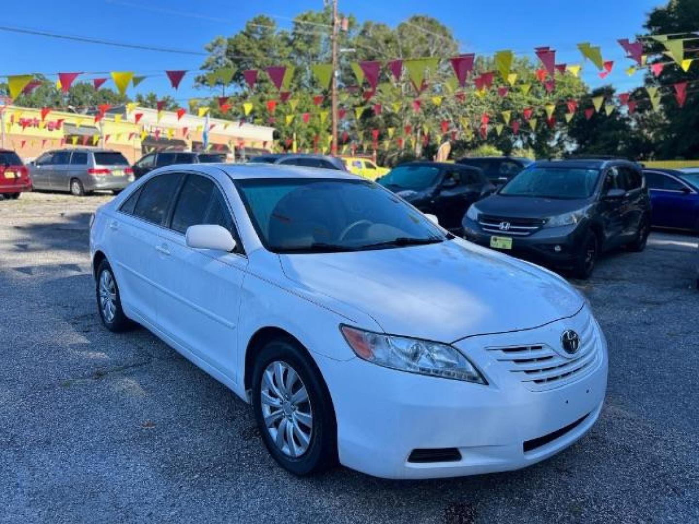 2009 White Toyota Camry LE 5-Spd AT (4T1BE46KX9U) with an 2.4L L4 DOHC 16V engine, 5-Speed Automatic transmission, located at 1806 Veterans Memorial Hwy SW, Austell, GA, 30168, (770) 944-9558, 33.817959, -84.606987 - Photo#2