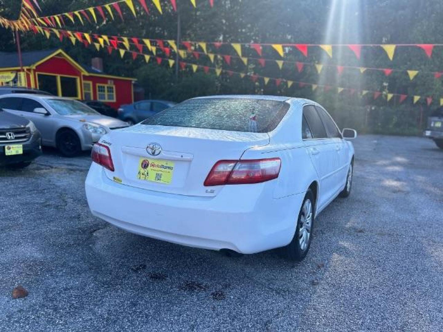 2009 White Toyota Camry LE 5-Spd AT (4T1BE46KX9U) with an 2.4L L4 DOHC 16V engine, 5-Speed Automatic transmission, located at 1806 Veterans Memorial Hwy SW, Austell, GA, 30168, (770) 944-9558, 33.817959, -84.606987 - Photo#3