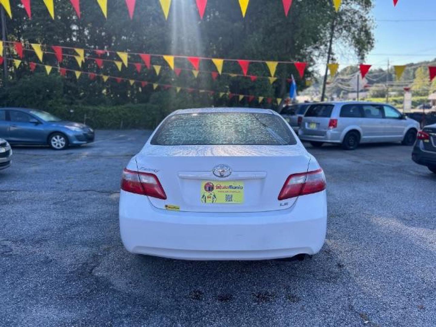 2009 White Toyota Camry LE 5-Spd AT (4T1BE46KX9U) with an 2.4L L4 DOHC 16V engine, 5-Speed Automatic transmission, located at 1806 Veterans Memorial Hwy SW, Austell, GA, 30168, (770) 944-9558, 33.817959, -84.606987 - Photo#4