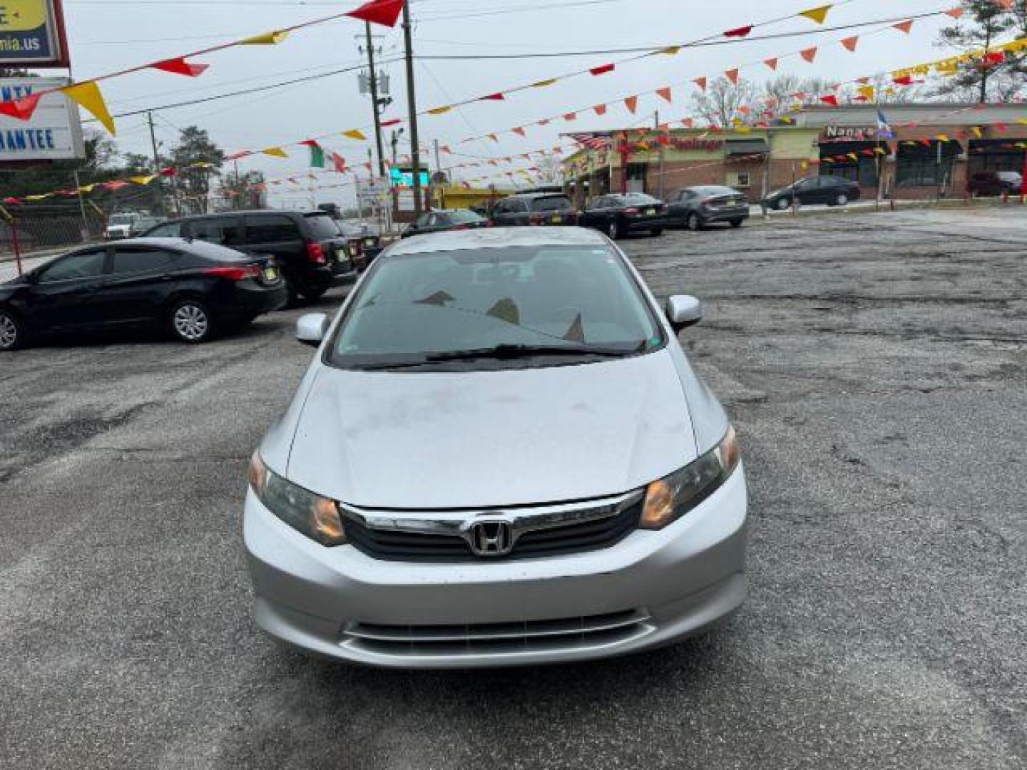 2012 Silver Honda Civic LX Sedan 5-Speed AT (2HGFB2F55CH) with an 1.8L L4 SOHC 16V engine, 5-Speed Automatic transmission, located at 1806 Veterans Memorial Hwy SW, Austell, GA, 30168, (770) 944-9558, 33.817959, -84.606987 - Photo#1