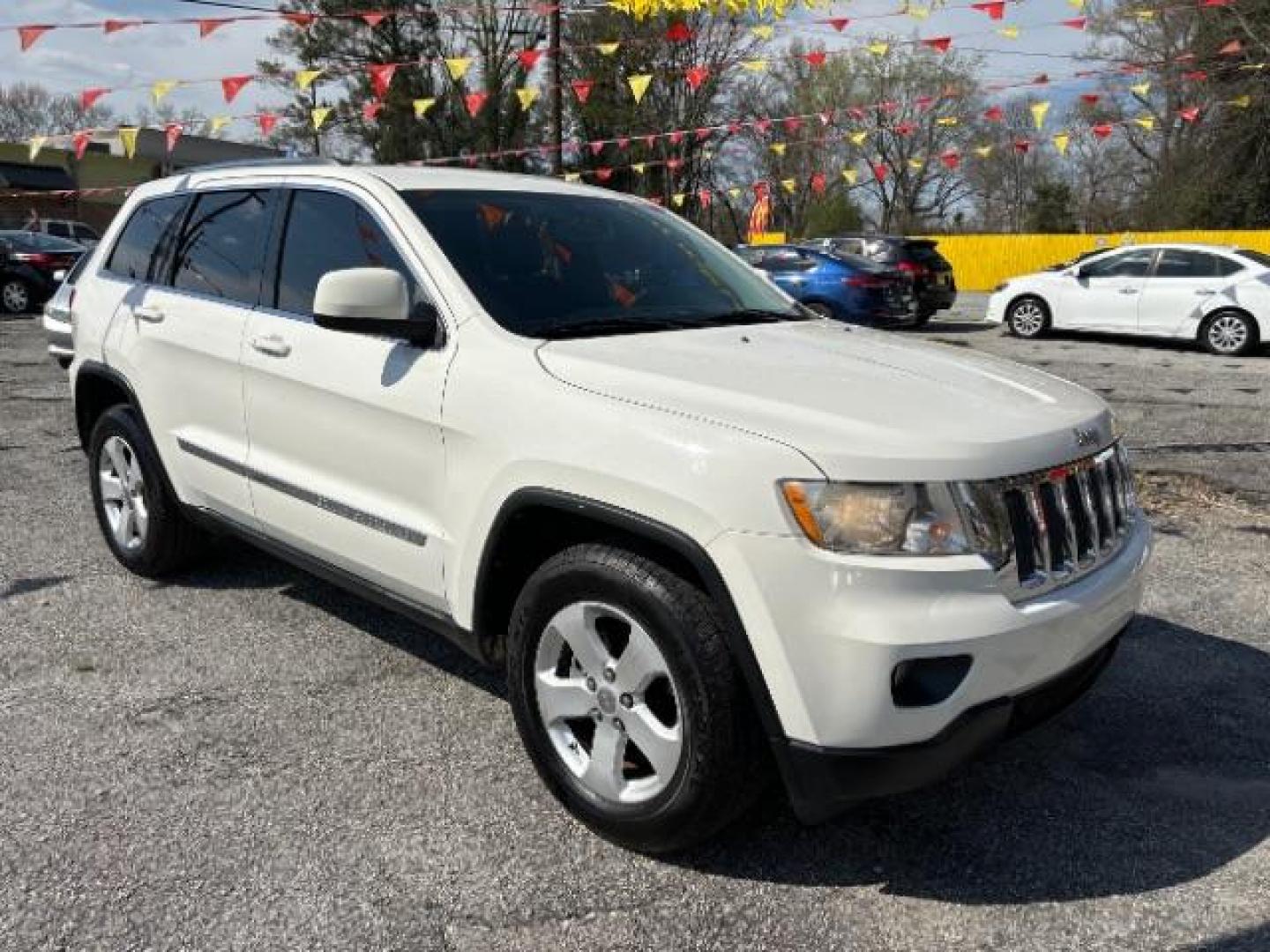 2012 White Jeep Grand Cherokee Laredo 2WD (1C4RJEAG5CC) with an 3.6L V6 DOHC 24V engine, 5-Speed Automatic transmission, located at 1806 Veterans Memorial Hwy SW, Austell, GA, 30168, (770) 944-9558, 33.817959, -84.606987 - Photo#0