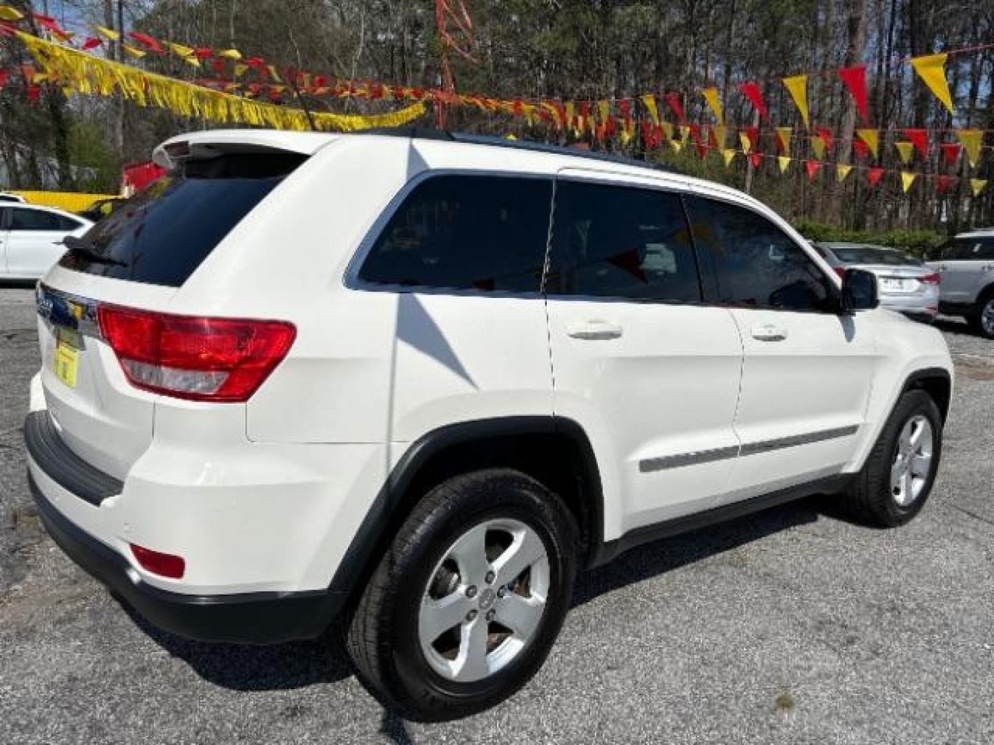 2012 White Jeep Grand Cherokee Laredo 2WD (1C4RJEAG5CC) with an 3.6L V6 DOHC 24V engine, 5-Speed Automatic transmission, located at 1806 Veterans Memorial Hwy SW, Austell, GA, 30168, (770) 944-9558, 33.817959, -84.606987 - Photo#6