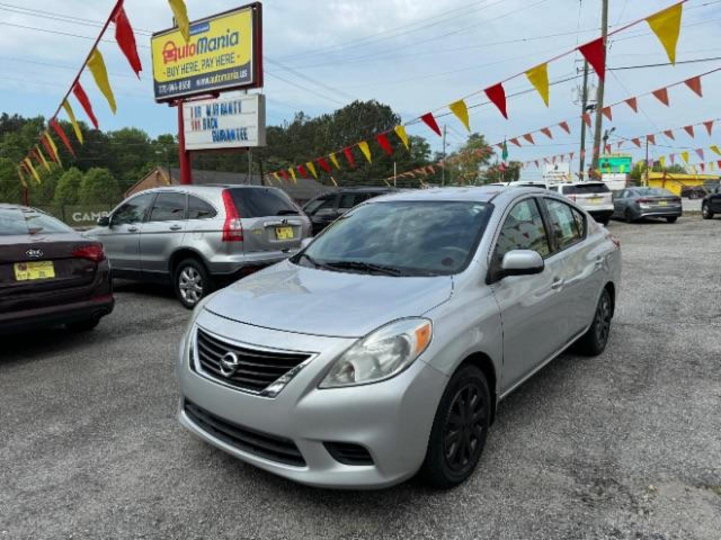 2014 Silver Nissan Versa 1.6 S 4A (3N1CN7AP5EL) with an 1.6L L4 DOHC 16V engine, 4-Speed Automatic transmission, located at 1806 Veterans Memorial Hwy SW, Austell, GA, 30168, (770) 944-9558, 33.817959, -84.606987 - Photo#0