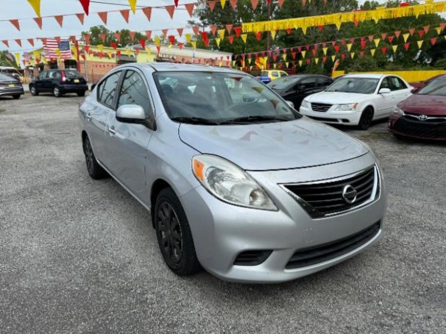 2014 Silver Nissan Versa 1.6 S 4A (3N1CN7AP5EL) with an 1.6L L4 DOHC 16V engine, 4-Speed Automatic transmission, located at 1806 Veterans Memorial Hwy SW, Austell, GA, 30168, (770) 944-9558, 33.817959, -84.606987 - Photo#2