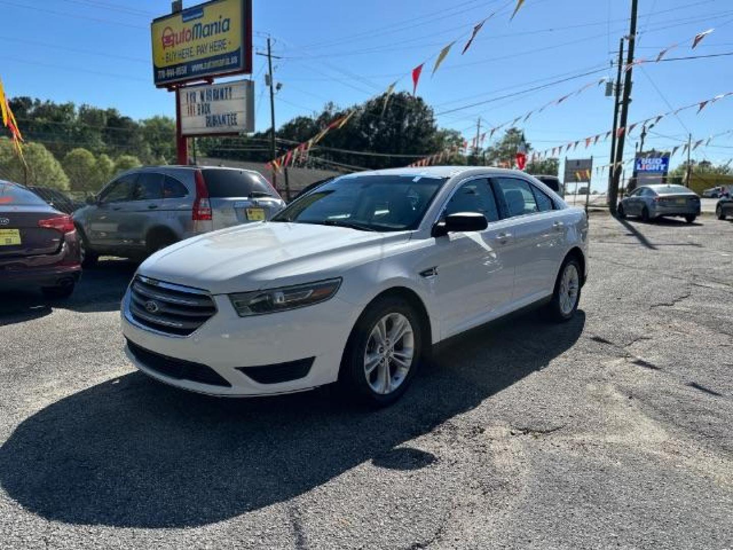 2016 WHITE Ford Taurus SE FWD (1FAHP2D88GG) with an 3.5L V6 DOHC 24V engine, 6-Speed Automatic transmission, located at 1806 Veterans Memorial Hwy SW, Austell, GA, 30168, (770) 944-9558, 33.817959, -84.606987 - Photo#0