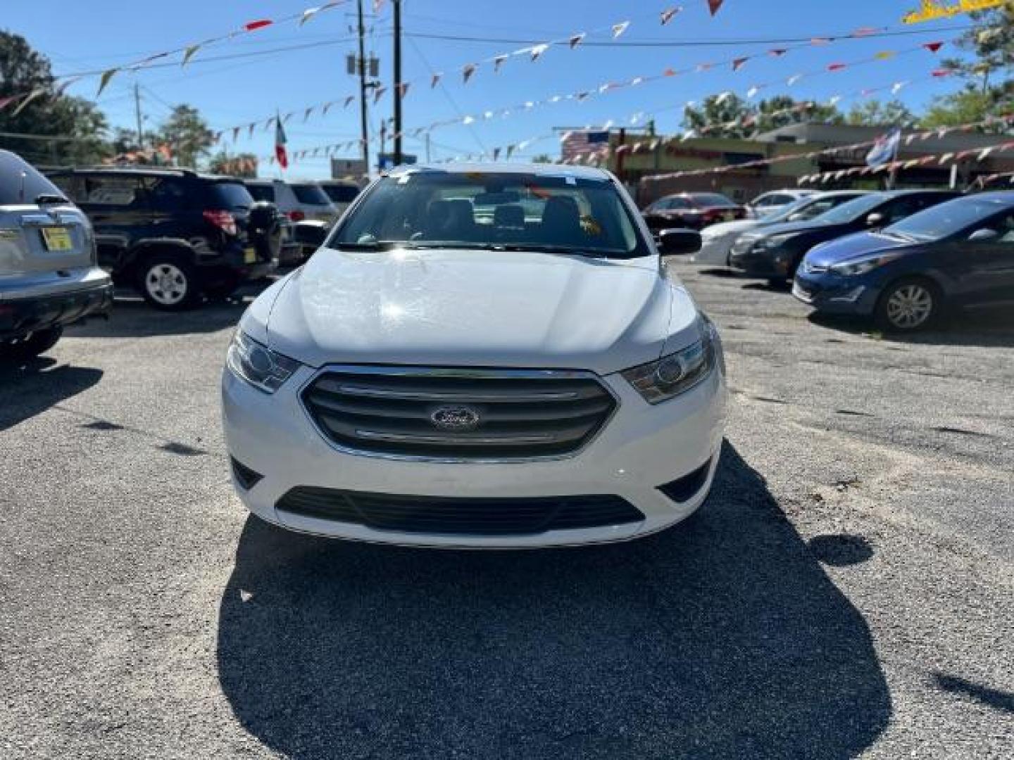 2016 WHITE Ford Taurus SE FWD (1FAHP2D88GG) with an 3.5L V6 DOHC 24V engine, 6-Speed Automatic transmission, located at 1806 Veterans Memorial Hwy SW, Austell, GA, 30168, (770) 944-9558, 33.817959, -84.606987 - Photo#1