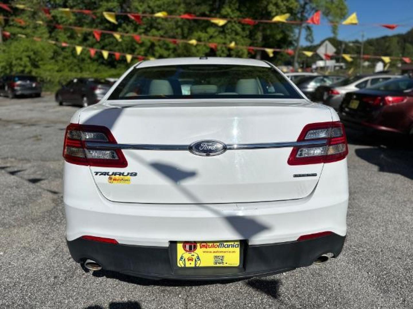 2016 WHITE Ford Taurus SE FWD (1FAHP2D88GG) with an 3.5L V6 DOHC 24V engine, 6-Speed Automatic transmission, located at 1806 Veterans Memorial Hwy SW, Austell, GA, 30168, (770) 944-9558, 33.817959, -84.606987 - Photo#5