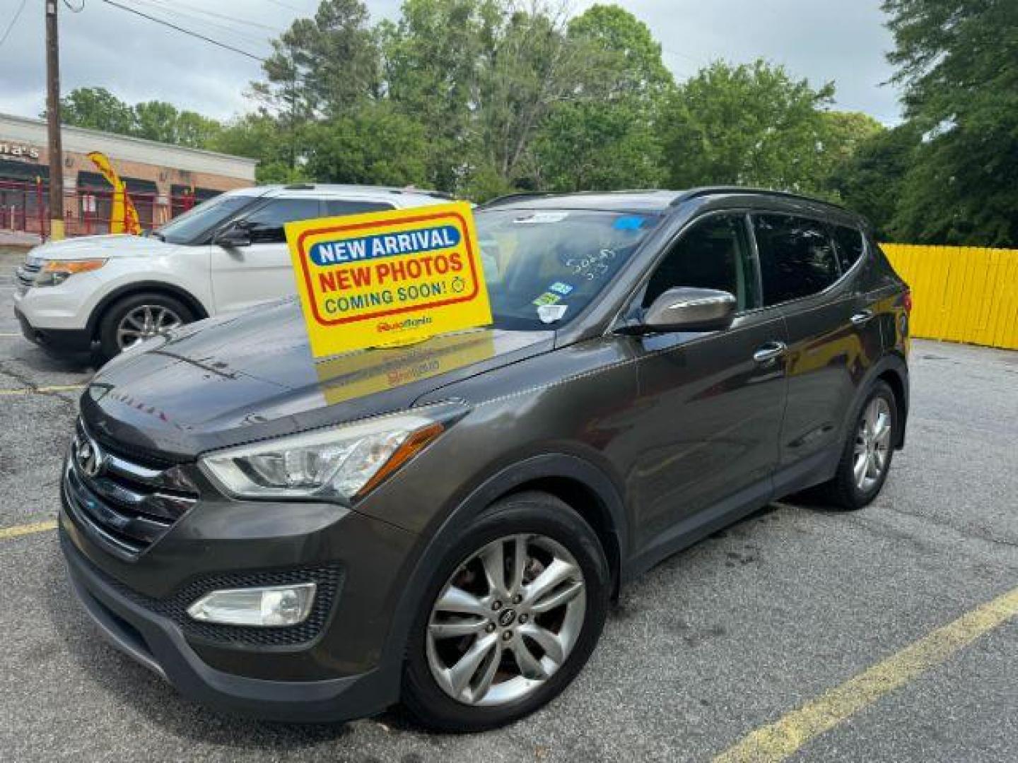 2013 BROWN Hyundai Santa Fe Sport 2.0 FWD (5XYZU3LA8DG) with an 2.0L L4 DOHC 16V engine, 6-Speed Automatic transmission, located at 1806 Veterans Memorial Hwy SW, Austell, GA, 30168, (770) 944-9558, 33.817959, -84.606987 - Photo#0