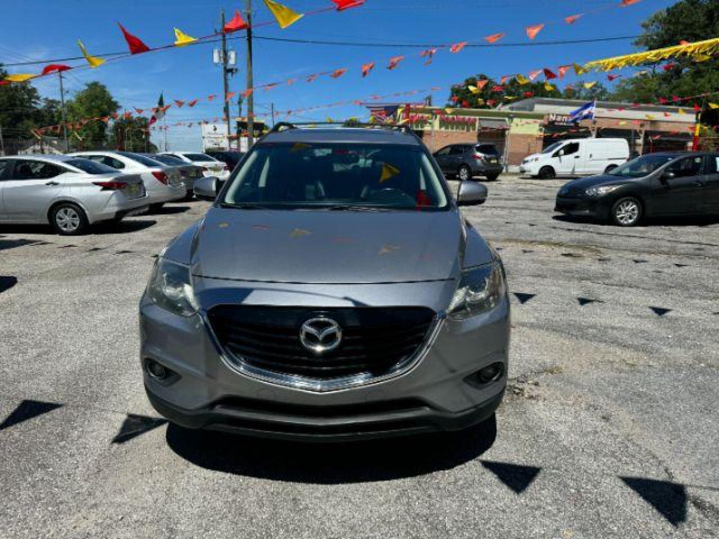 2015 Silver Mazda CX-9 Grand Touring (JM3TB2DAXF0) with an 3.7L V6 DOHC 24V engine, 6-Speed Automatic transmission, located at 1806 Veterans Memorial Hwy SW, Austell, GA, 30168, (770) 944-9558, 33.817959, -84.606987 - Photo#2