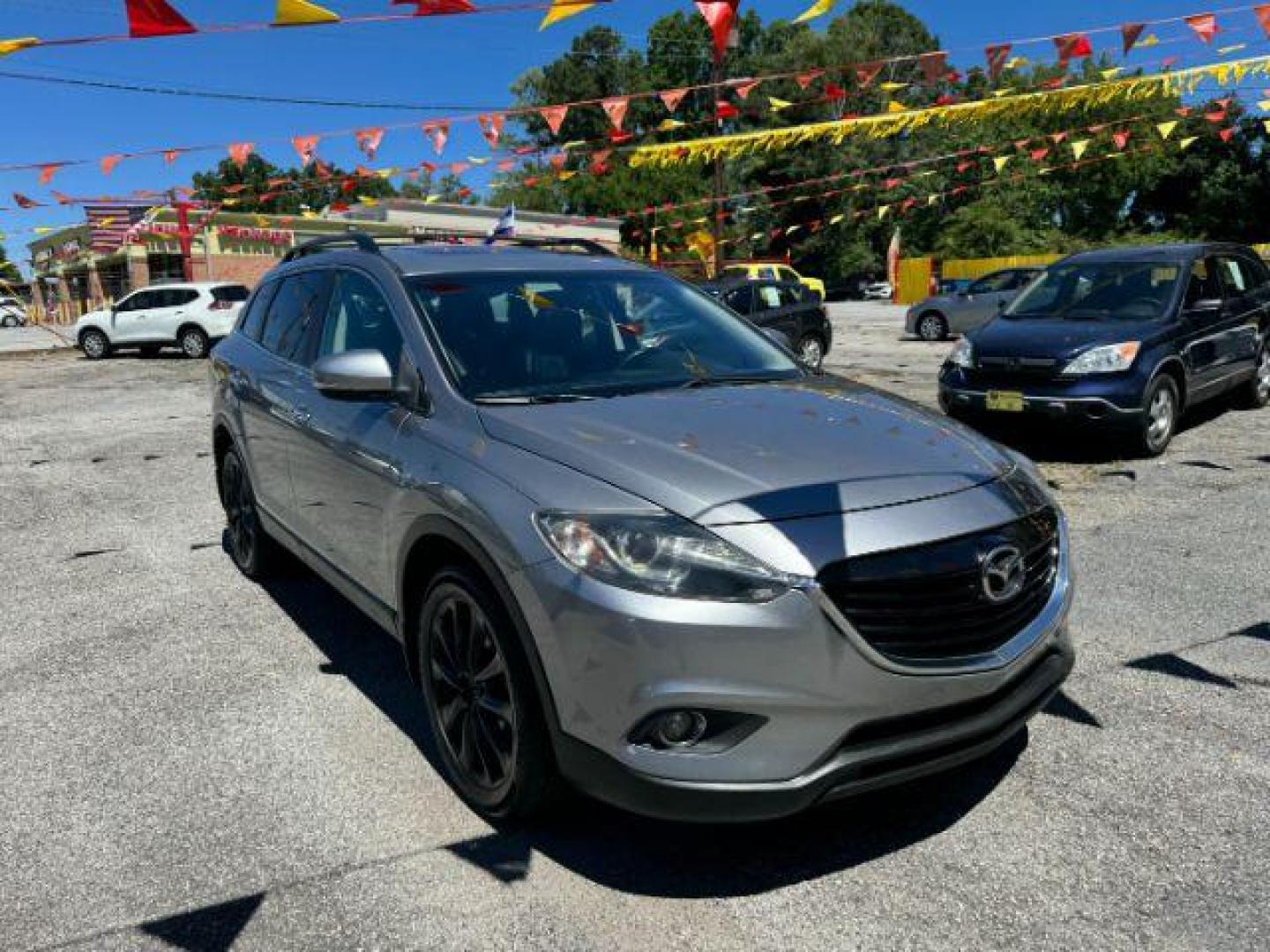 2015 Silver Mazda CX-9 Grand Touring (JM3TB2DAXF0) with an 3.7L V6 DOHC 24V engine, 6-Speed Automatic transmission, located at 1806 Veterans Memorial Hwy SW, Austell, GA, 30168, (770) 944-9558, 33.817959, -84.606987 - Photo#3