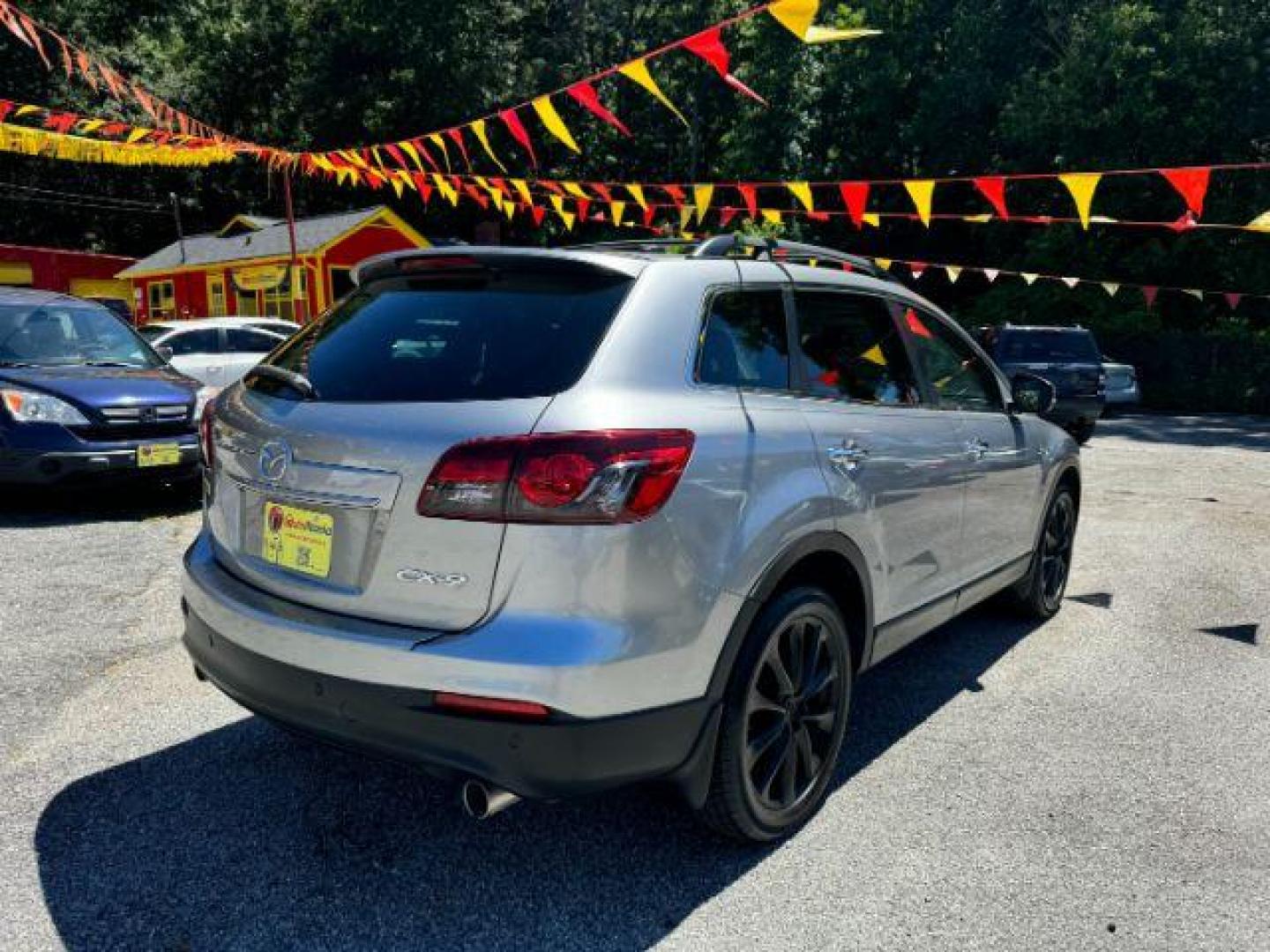 2015 Silver Mazda CX-9 Grand Touring (JM3TB2DAXF0) with an 3.7L V6 DOHC 24V engine, 6-Speed Automatic transmission, located at 1806 Veterans Memorial Hwy SW, Austell, GA, 30168, (770) 944-9558, 33.817959, -84.606987 - Photo#4