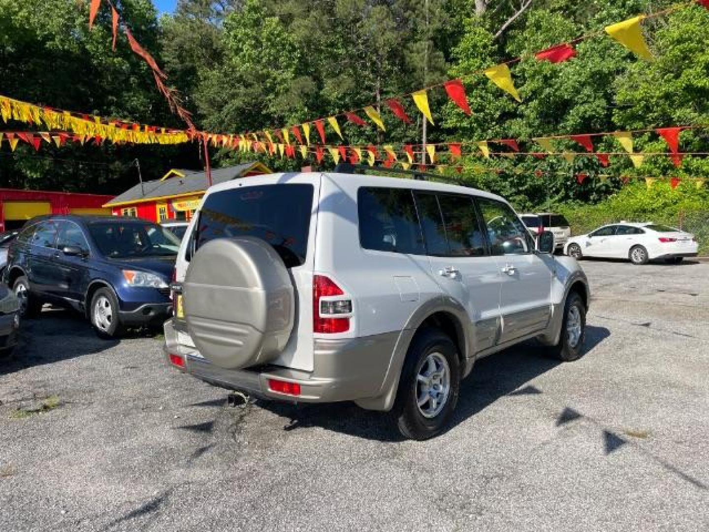 2002 White Mitsubishi Montero SPORT UTILITY 4-DR (JA4MW51R42J) with an 3.5L V6 SOHC 24V engine, 5-Speed Automatic transmission, located at 1806 Veterans Memorial Hwy SW, Austell, GA, 30168, (770) 944-9558, 33.817959, -84.606987 - Photo#5