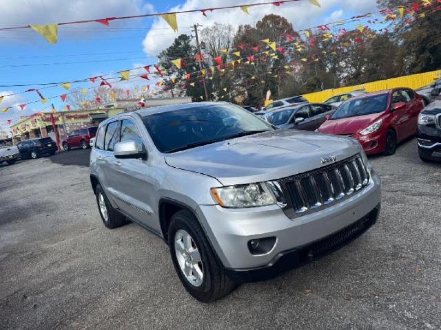 2012 Silver Jeep Grand Cherokee Laredo 2WD (1C4RJEAG6CC) with an 3.6L V6 DOHC 24V engine, 5-Speed Automatic transmission, located at 1806 Veterans Memorial Hwy SW, Austell, GA, 30168, (770) 944-9558, 33.817959, -84.606987 - Photo#2