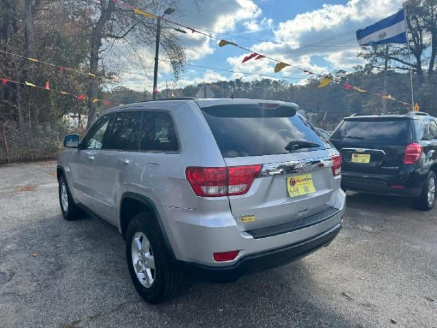 2012 Silver Jeep Grand Cherokee Laredo 2WD (1C4RJEAG6CC) with an 3.6L V6 DOHC 24V engine, 5-Speed Automatic transmission, located at 1806 Veterans Memorial Hwy SW, Austell, GA, 30168, (770) 944-9558, 33.817959, -84.606987 - Photo#6