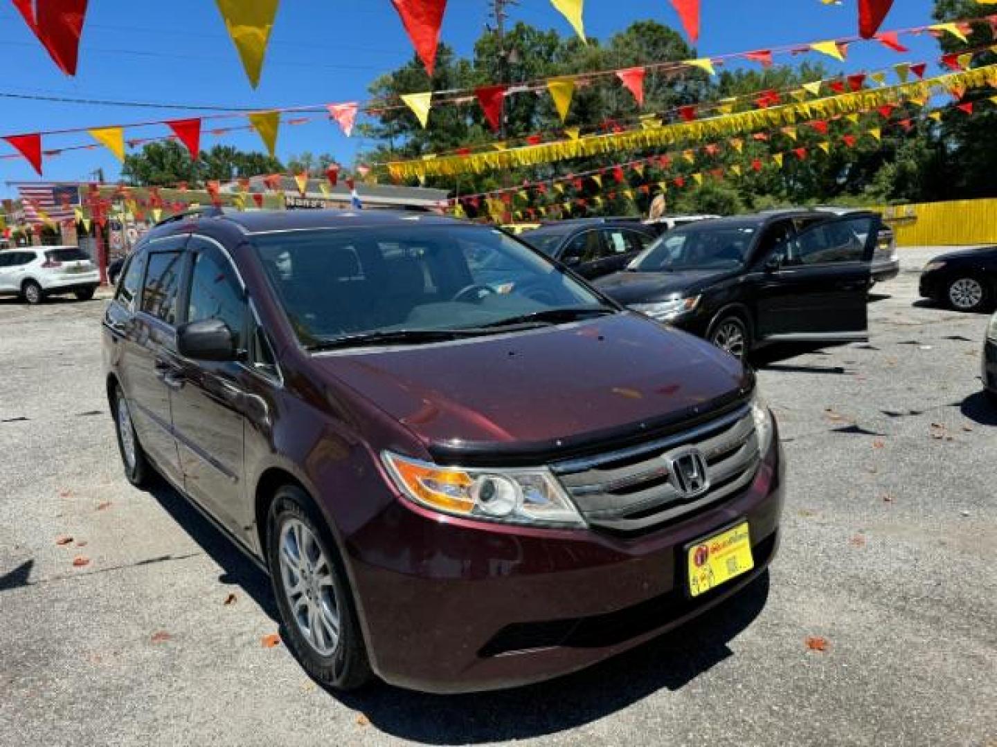 2012 Maroon Honda Odyssey EX (5FNRL5H44CB) with an 3.5L V6 SOHC 24V engine, 5-Speed Automatic transmission, located at 1806 Veterans Memorial Hwy SW, Austell, GA, 30168, (770) 944-9558, 33.817959, -84.606987 - Photo#2