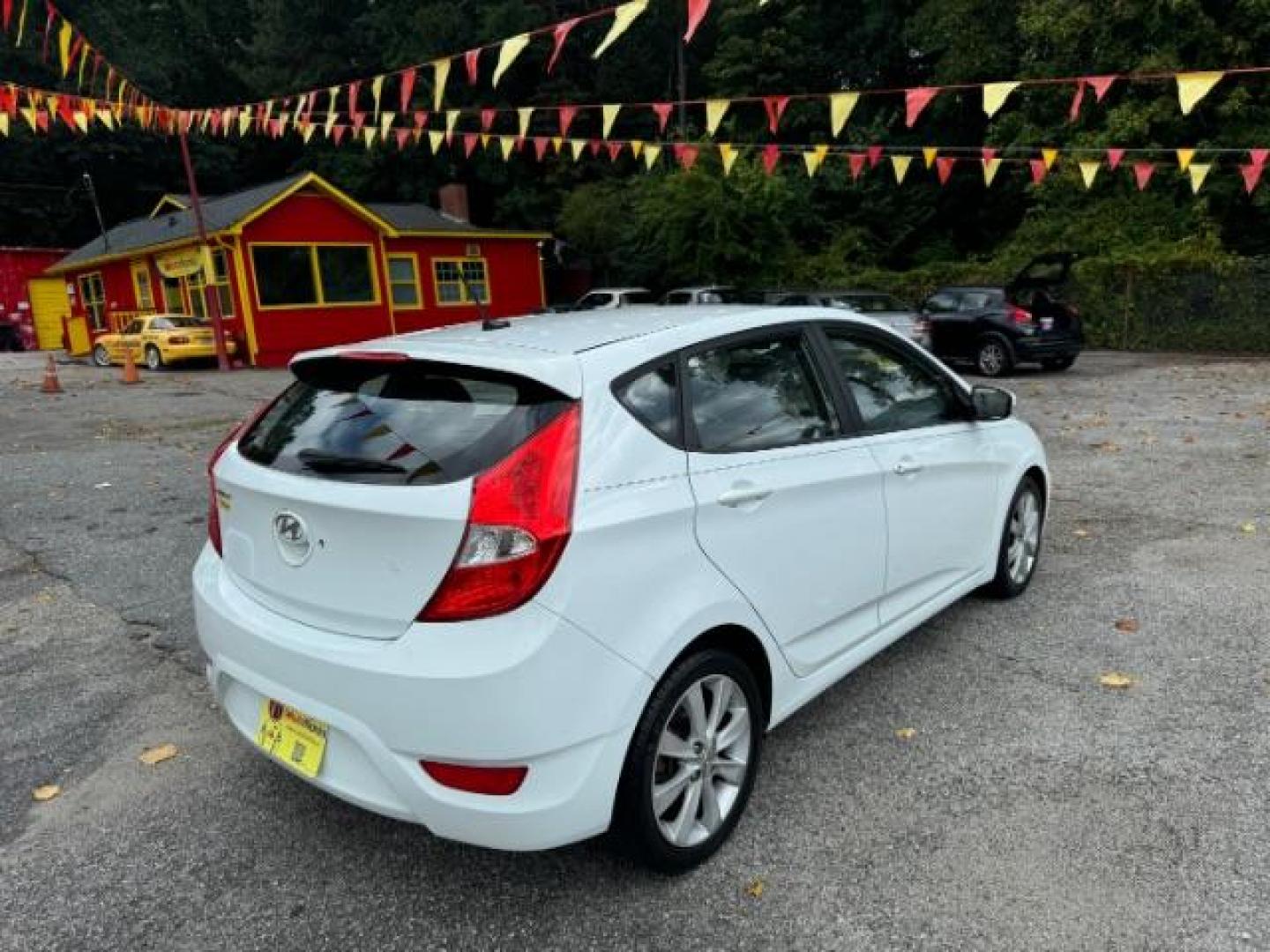 2014 White Hyundai Accent SE 5-Door (KMHCU5AE2EU) with an 1.6L L4 DOHC 16V engine, located at 1806 Veterans Memorial Hwy SW, Austell, GA, 30168, (770) 944-9558, 33.817959, -84.606987 - Photo#3