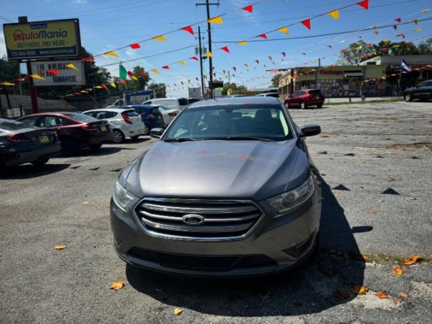 2013 Gray Ford Taurus SEL FWD (1FAHP2E8XDG) with an 3.5L V6 DOHC 24V engine, 6-Speed Automatic transmission, located at 1806 Veterans Memorial Hwy SW, Austell, GA, 30168, (770) 944-9558, 33.817959, -84.606987 - Photo#1