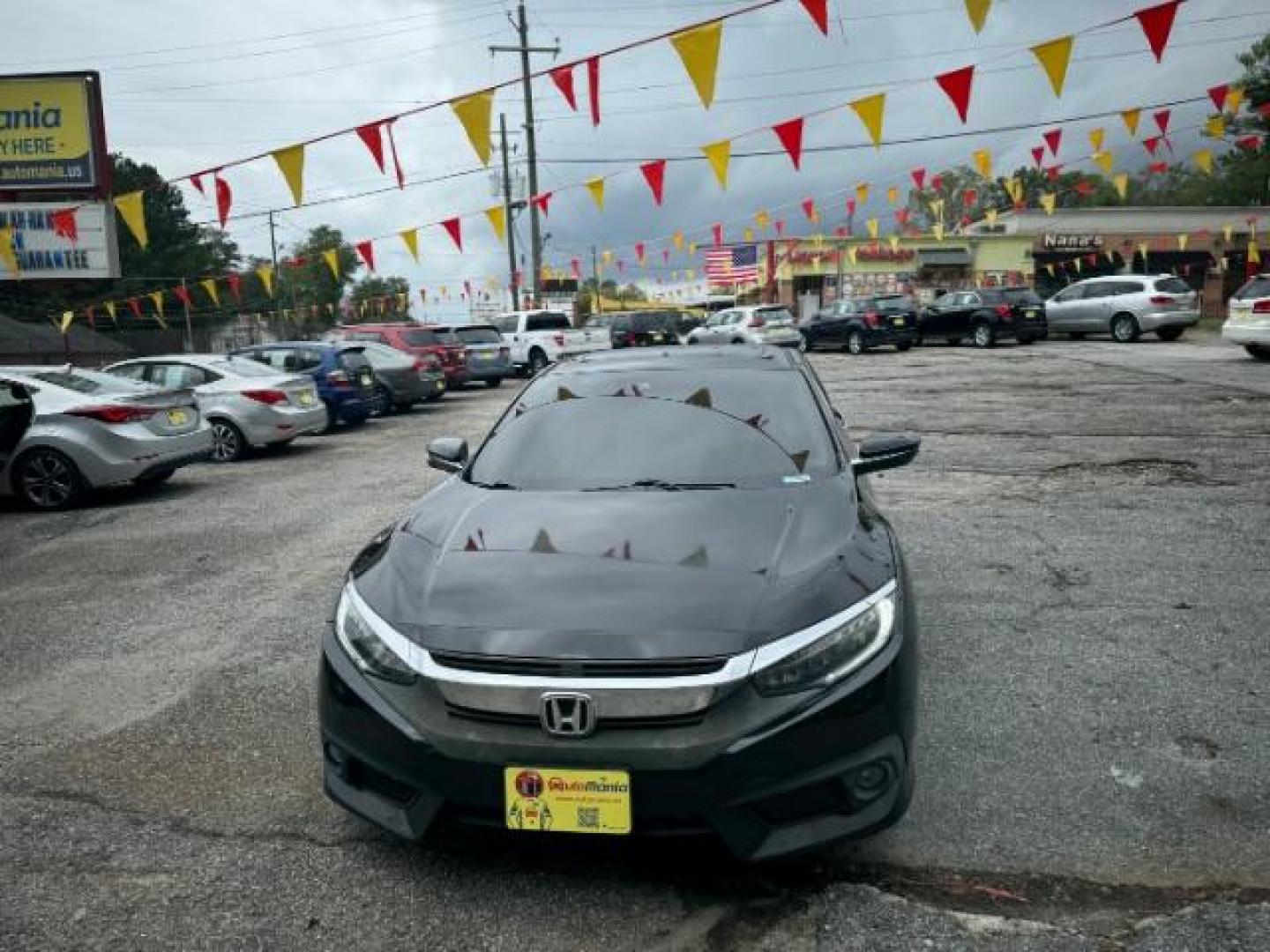 2016 Black Honda Civic Touring Sedan CVT (19XFC1F94GE) with an 1.5L L4 DOHC 16V TURBO engine, Continuously Variable Transmission transmission, located at 1806 Veterans Memorial Hwy SW, Austell, GA, 30168, (770) 944-9558, 33.817959, -84.606987 - Photo#0