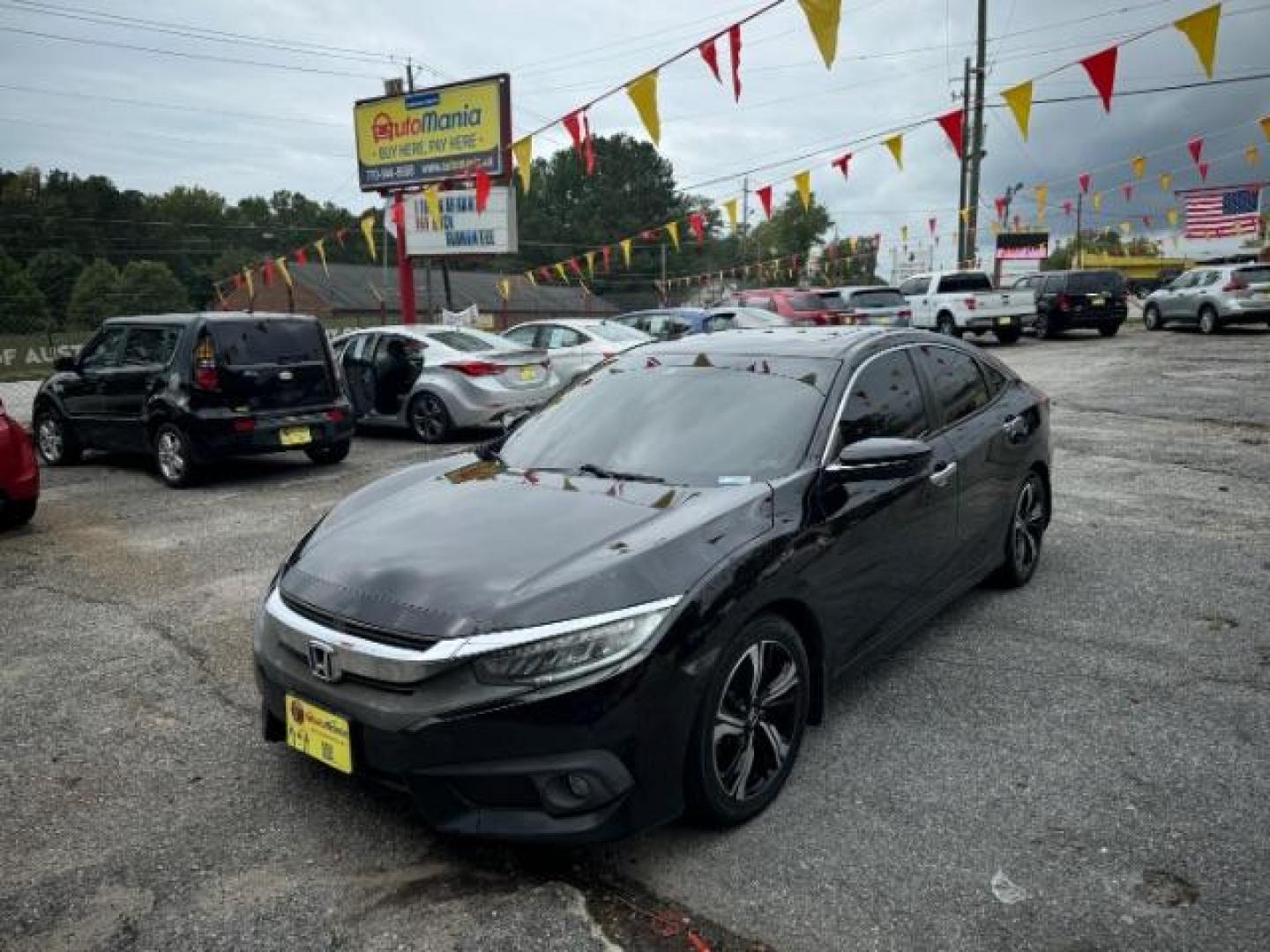 2016 Black Honda Civic Touring Sedan CVT (19XFC1F94GE) with an 1.5L L4 DOHC 16V TURBO engine, Continuously Variable Transmission transmission, located at 1806 Veterans Memorial Hwy SW, Austell, GA, 30168, (770) 944-9558, 33.817959, -84.606987 - Photo#1