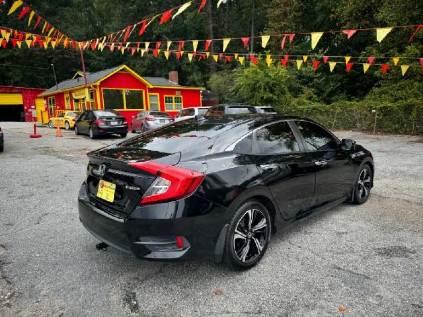 2016 Black Honda Civic Touring Sedan CVT (19XFC1F94GE) with an 1.5L L4 DOHC 16V TURBO engine, Continuously Variable Transmission transmission, located at 1806 Veterans Memorial Hwy SW, Austell, GA, 30168, (770) 944-9558, 33.817959, -84.606987 - Photo#2