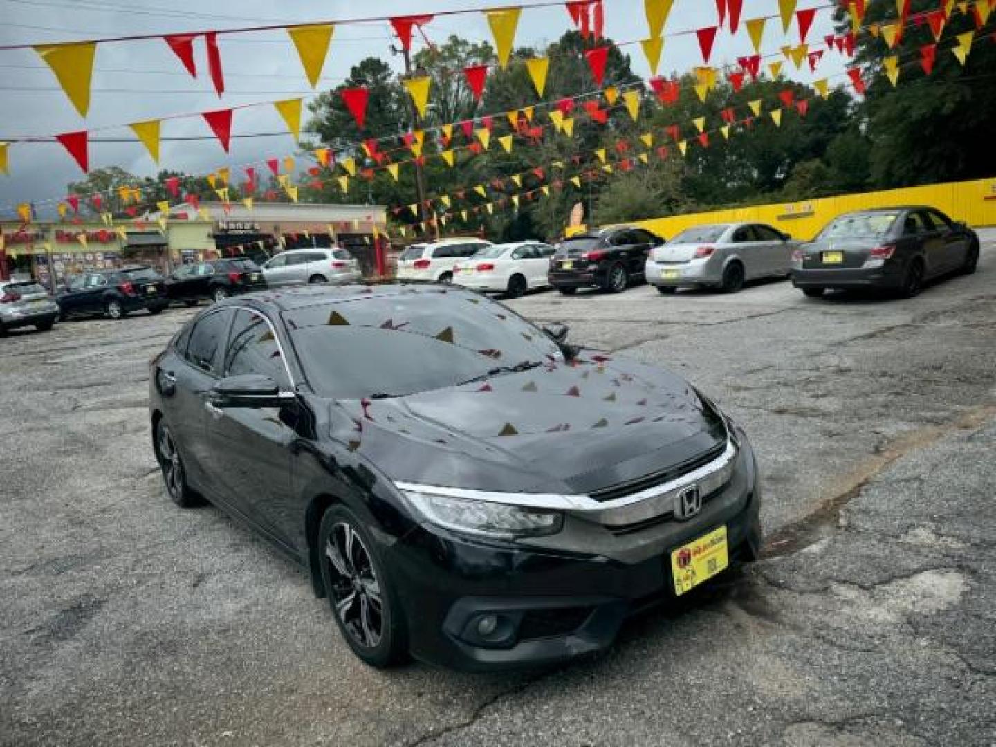 2016 Black Honda Civic Touring Sedan CVT (19XFC1F94GE) with an 1.5L L4 DOHC 16V TURBO engine, Continuously Variable Transmission transmission, located at 1806 Veterans Memorial Hwy SW, Austell, GA, 30168, (770) 944-9558, 33.817959, -84.606987 - Photo#3