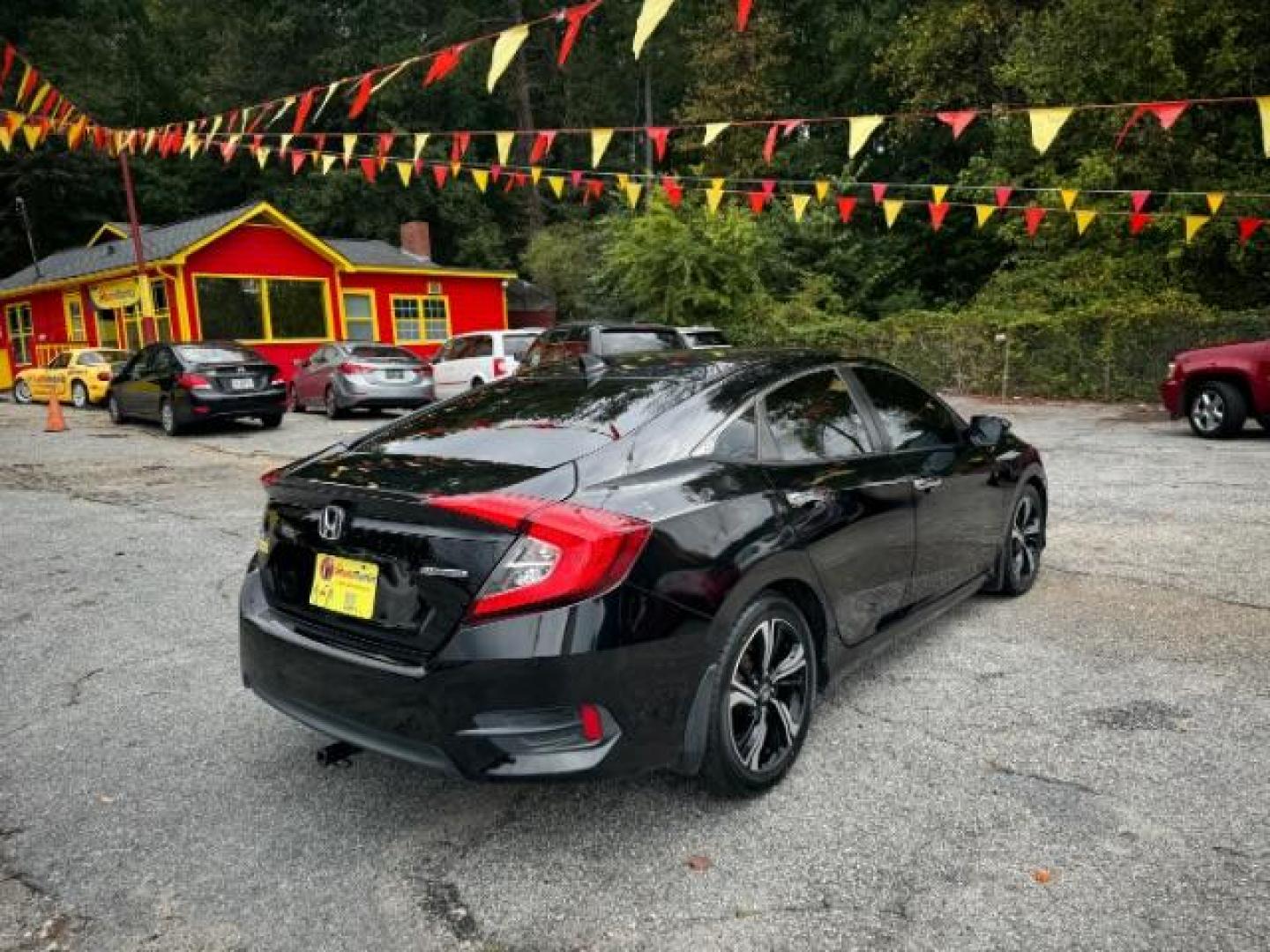 2016 Black Honda Civic Touring Sedan CVT (19XFC1F94GE) with an 1.5L L4 DOHC 16V TURBO engine, Continuously Variable Transmission transmission, located at 1806 Veterans Memorial Hwy SW, Austell, GA, 30168, (770) 944-9558, 33.817959, -84.606987 - Photo#4