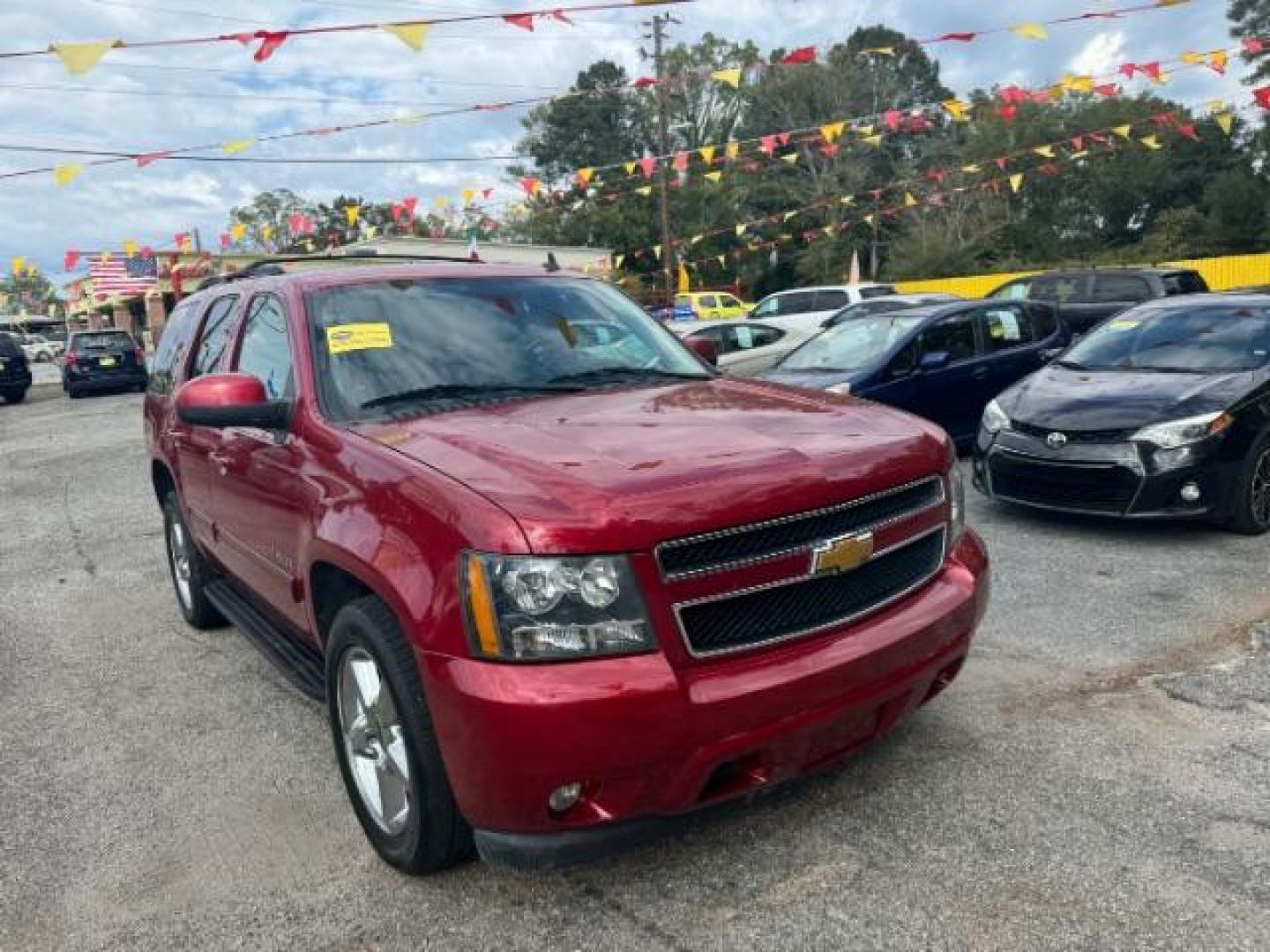 2014 Red Chevrolet Tahoe LT 2WD (1GNSCBE03ER) with an 5.3L V8 OHV 16V FFV engine, 6-Speed Automatic transmission, located at 1806 Veterans Memorial Hwy SW, Austell, GA, 30168, (770) 944-9558, 33.817959, -84.606987 - Photo#1